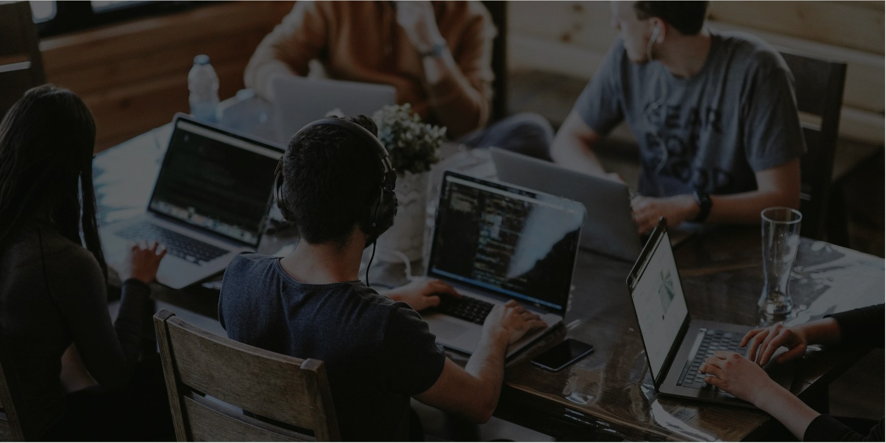 A team working together around a table with laptops